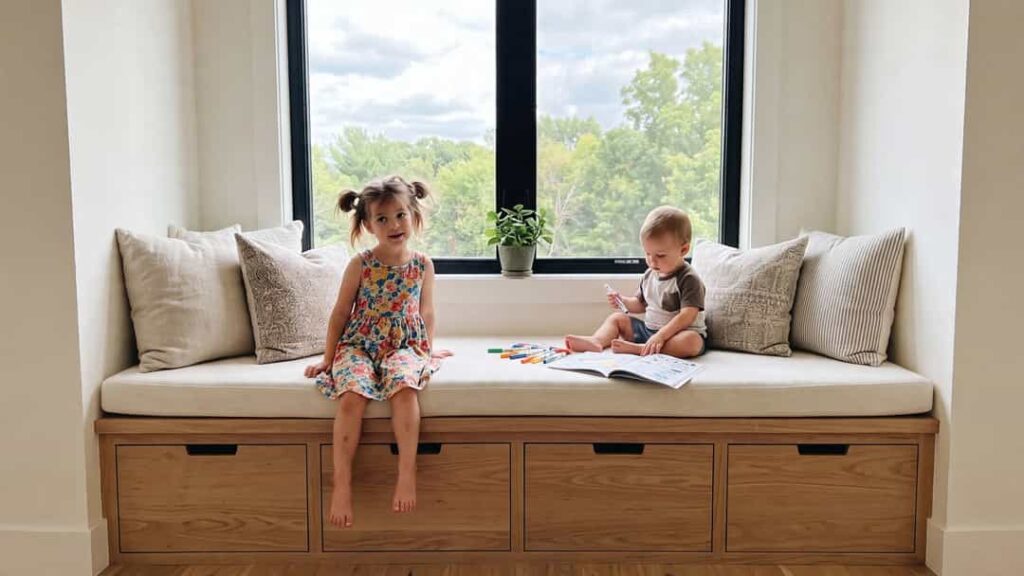 Kids window reading nook with cushioned built-in seating and large storage drawers underneath
